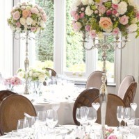 Cherie-Kelly-Fawsley-Hall-Wedding-reception-top-and-guests-table-candelabra-flower-arrangements-tall-and-low-centrepieces-with-candles