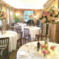 Coral, Peach and Pink Summer Wedding Flowers tall candelabra centrepieces and Cake Table in Burgh House Cherie Kelly London