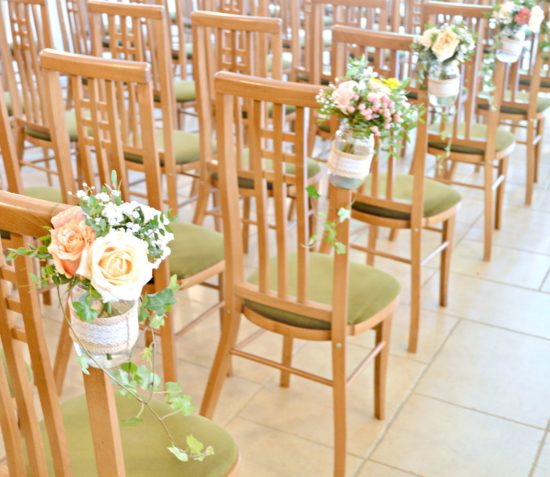 Rustic Orange and Peach Wedding Ceremony Aisle Flowers in Jam Jars at Rivervale Barn Hampshire Cherie Kelly