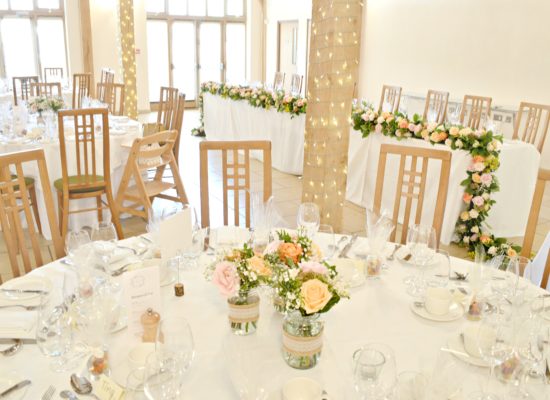 Rustic Orange and Peach Wedding Reception Flowers in Jam Jars Centrepieces at Rivervale Barn Hampshire Cherie Kelly 