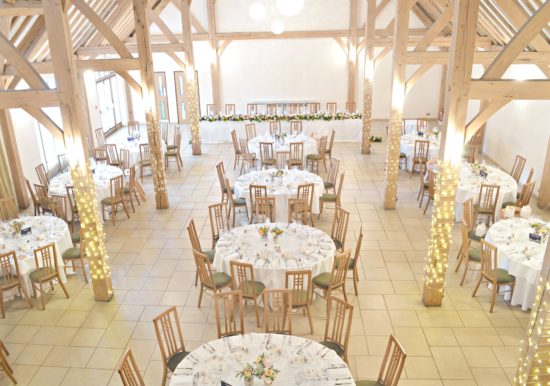 Rustic Orange and Peach Wedding Reception Flowers in Jam Jars Centrepieces at Rivervale Barn Hampshire Cherie Kelly 